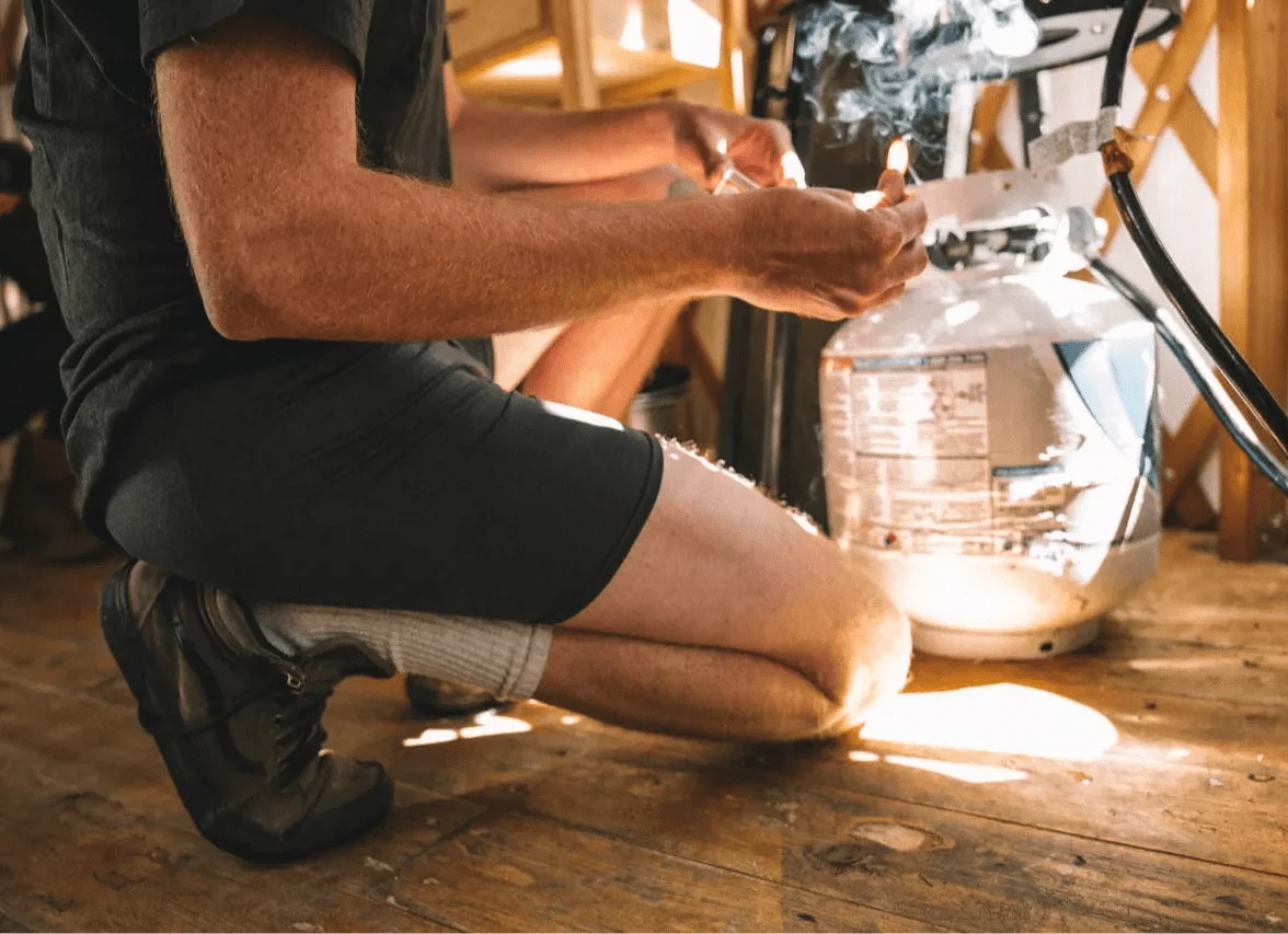 a man wearing Ridge Merino boxer briefs sets up camp in a yurt