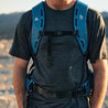 A close-up of a man wearing the Merino Tencel Tee with a backpack on