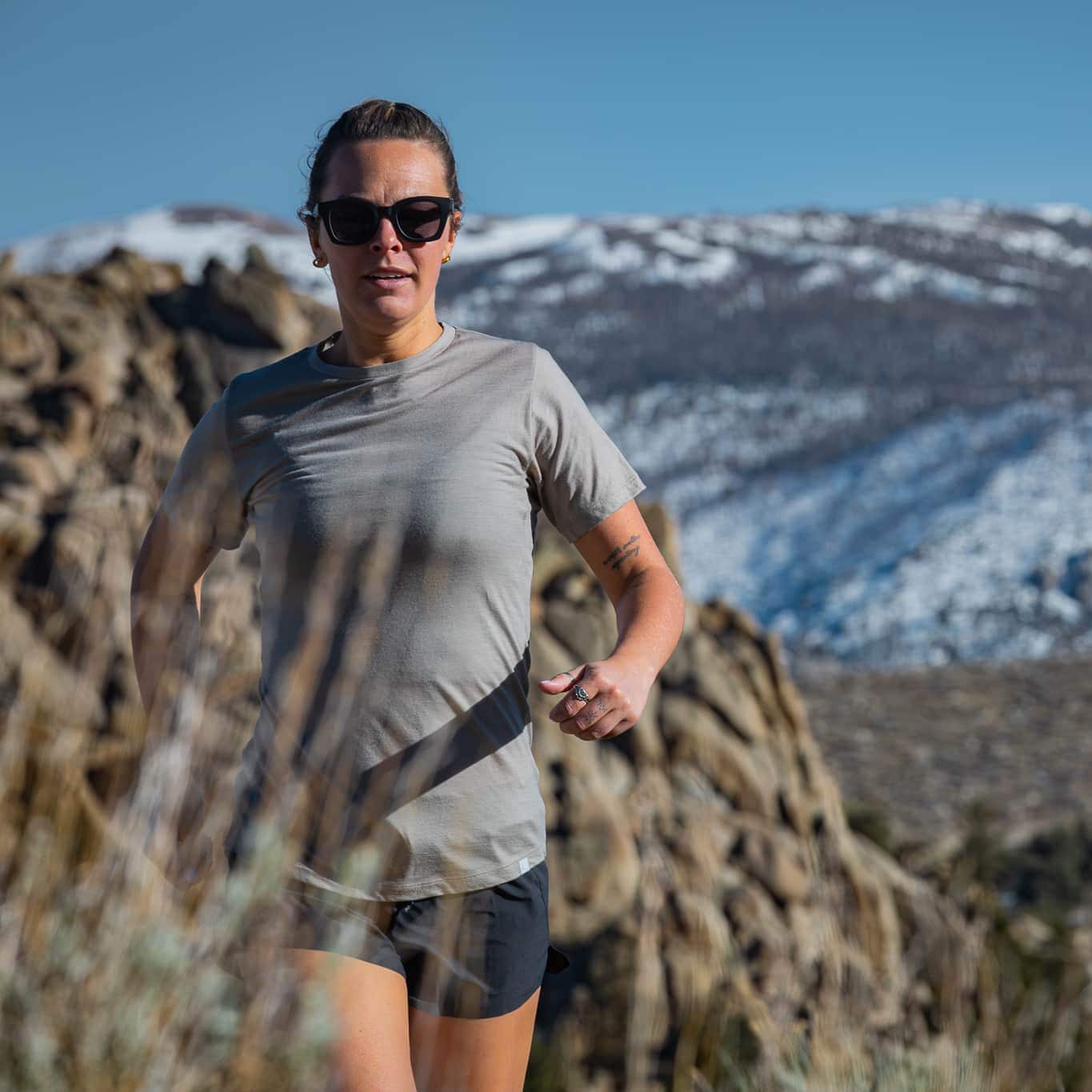 a woman trail running in a Pursuit Ultralight Tee