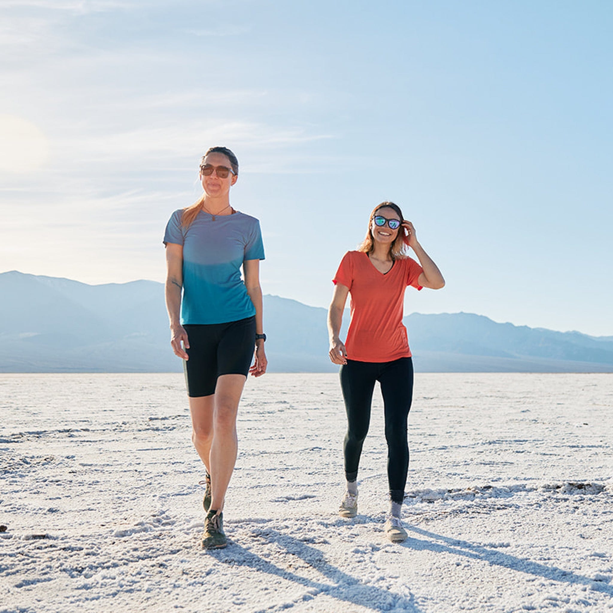 Two women wearing Wander shirts from Ridge Merino walking through Death Valley