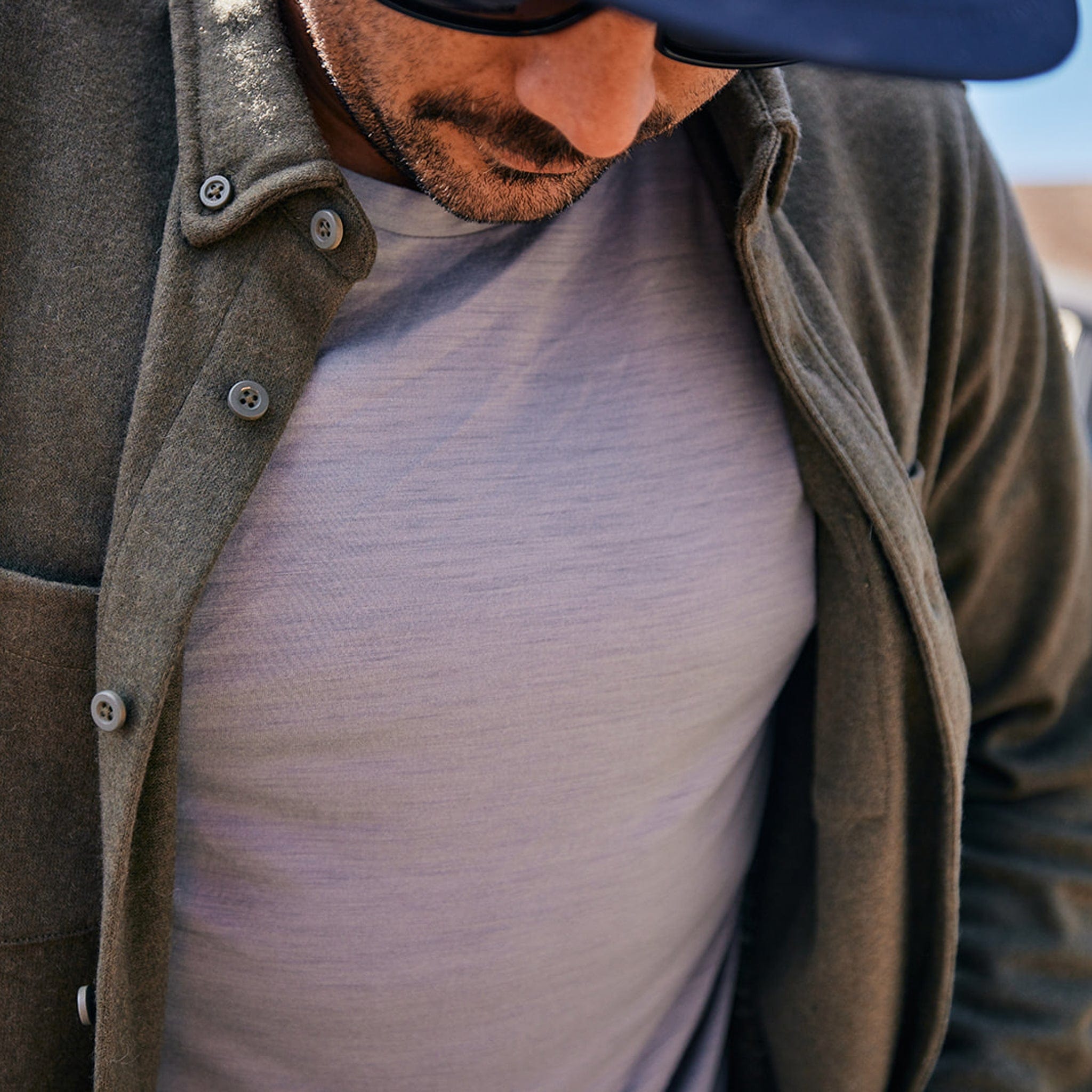 a close-up of the Journey Merino Tee under the Hammil Flannel