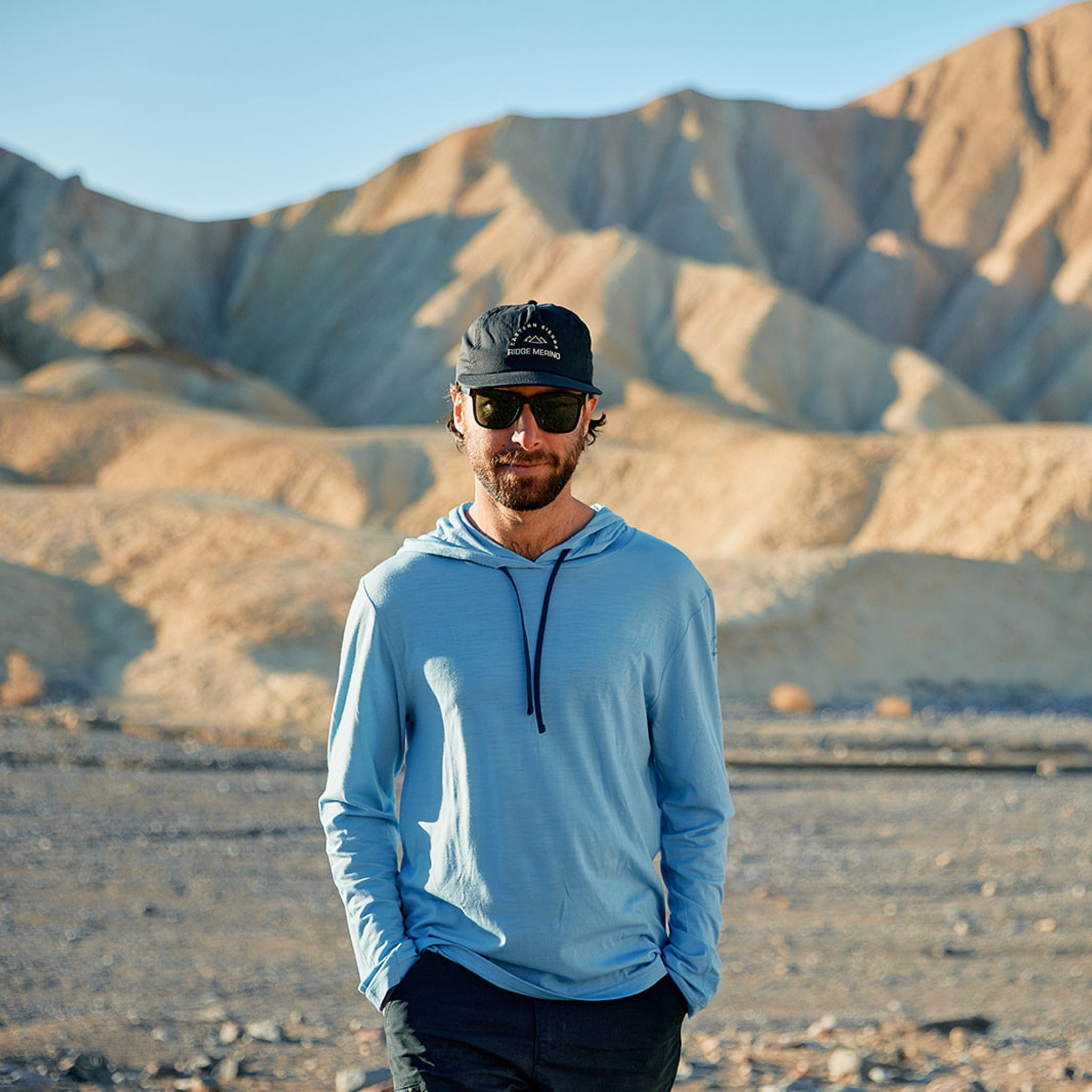 a man walks through the desert wearing the Solstice Sun Hoodie