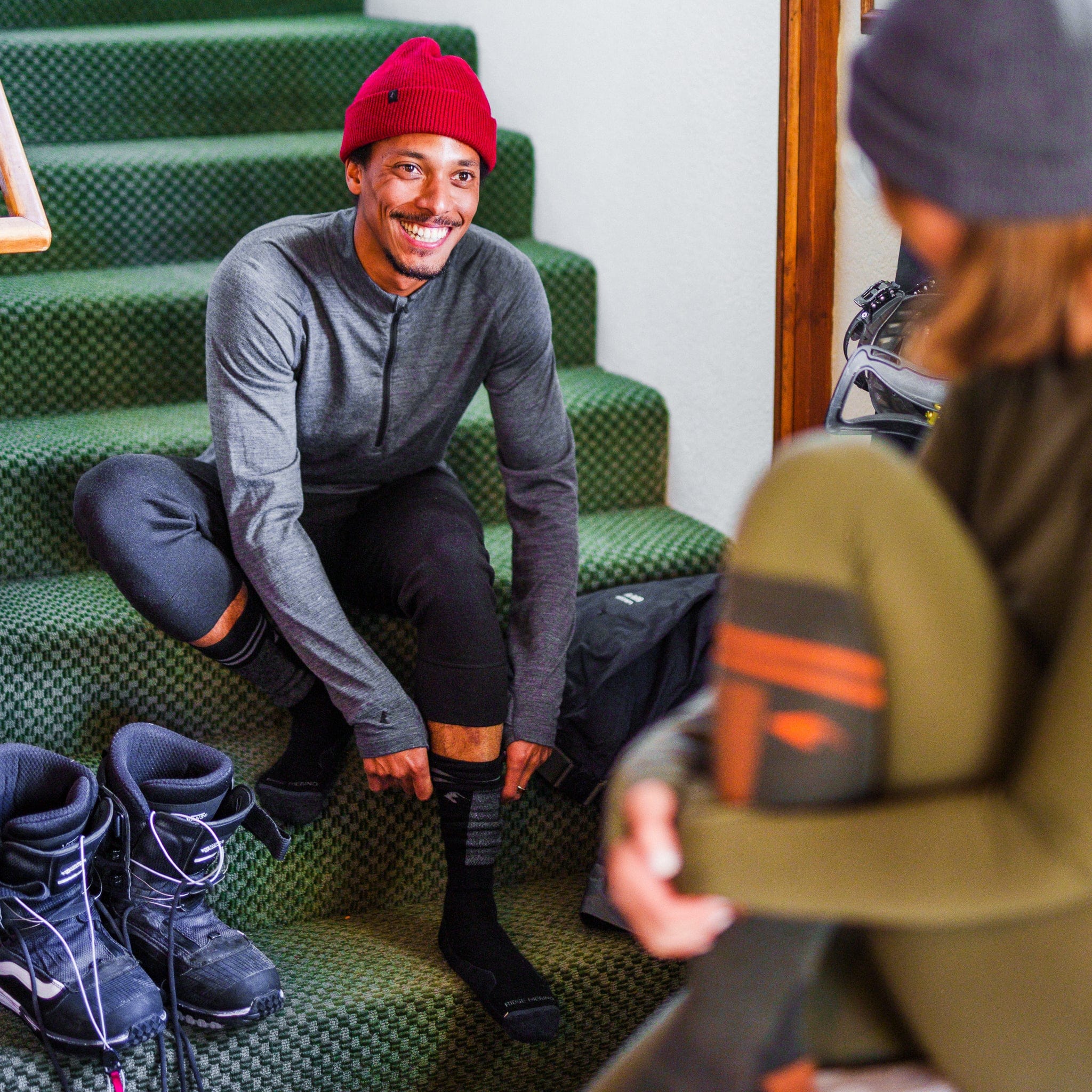 4 length bottoms and a read beanie getting ready for a ski day