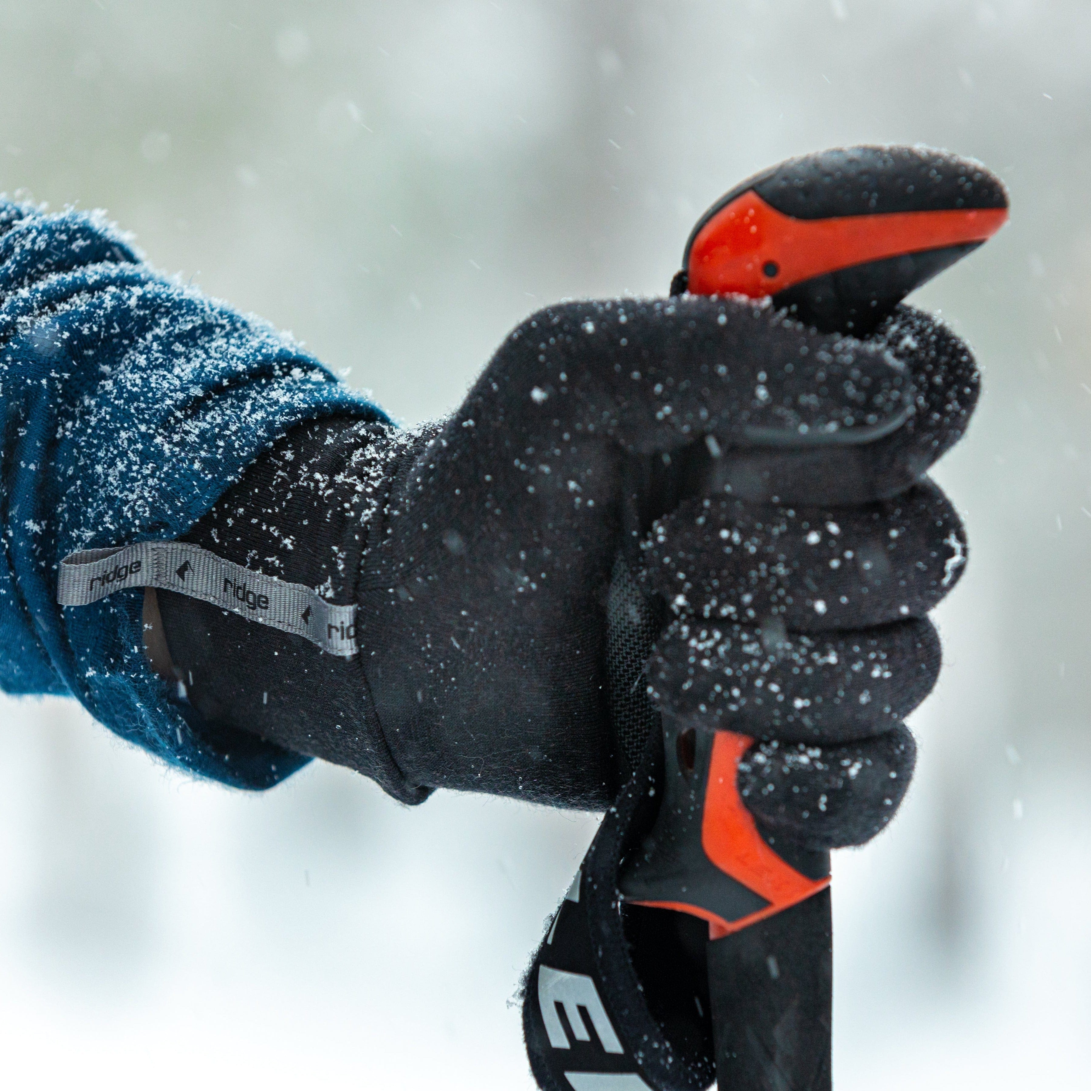 a skier wearing glove liners on a snowy day