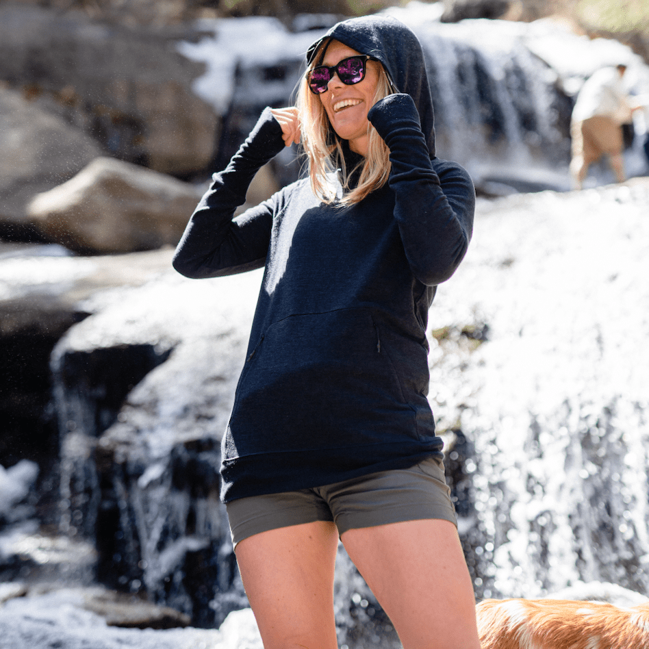 A woman laughs wearing a Natural Tencel Hoodie
