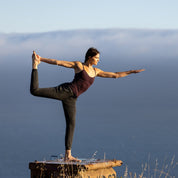 A woman does yoga outside wearing the Merino Wool Shelf Bra Camisole