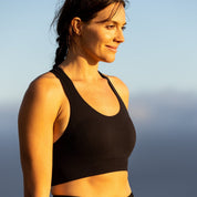a woman wearing the Ridge Merino Wool Seamless Sports Bra