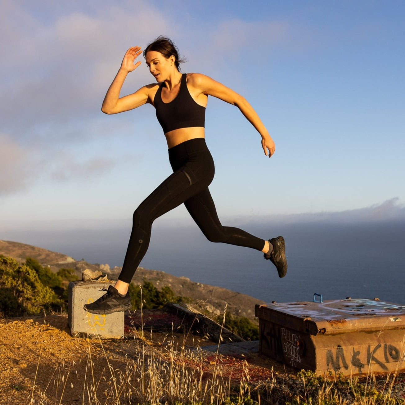 a woman jumping on a run wearing a Ridge Merino wool sports bra and Ridge Crowley Compression Tights