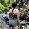 A woman wearing Ridge Merino boy short underwear by a stream